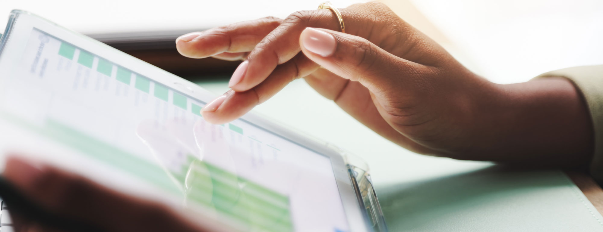 Effective Strategies For Private School Marketing Blog - Woman's hand scrolling ipad to review website analytics