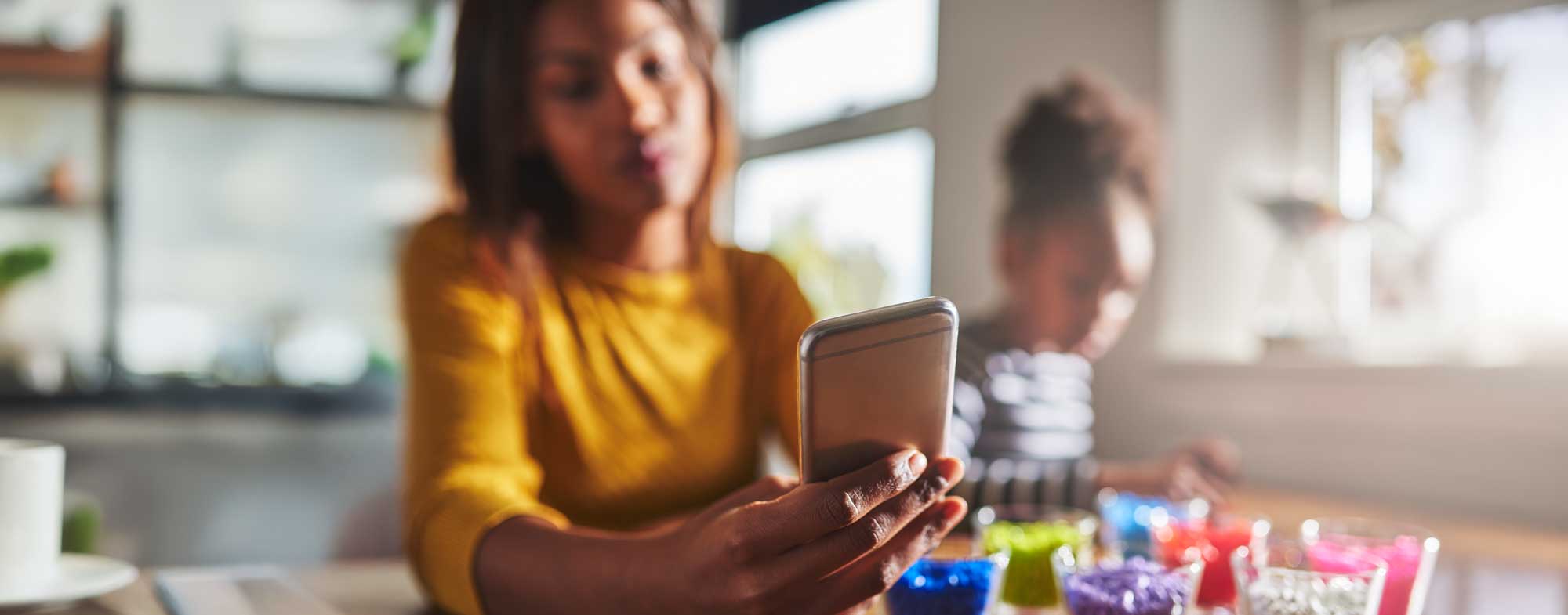 Amplify - Inbound marketing for private schools blog article - banner of mum researching private schools on her phone while daughter plays.jpg