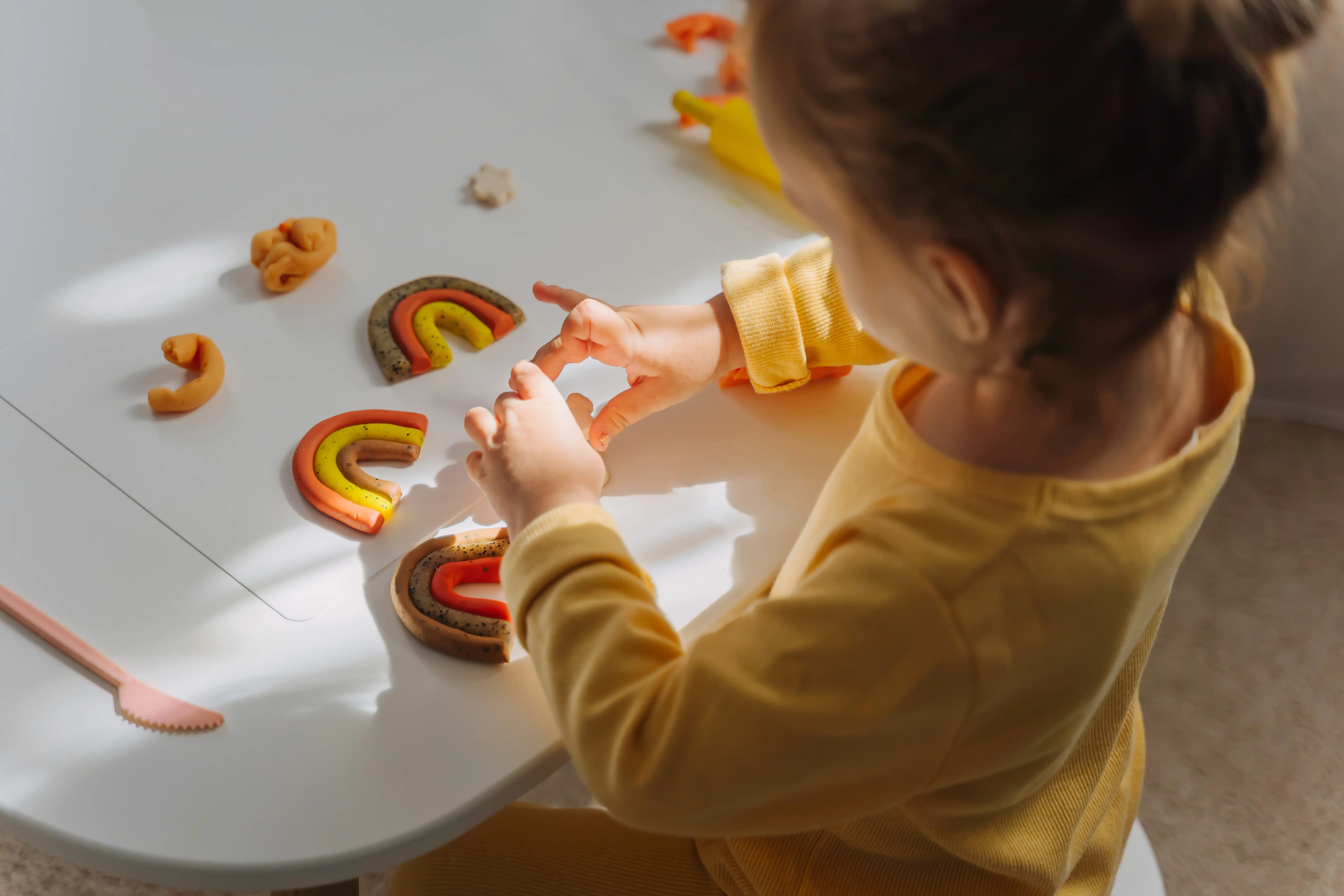 Private School Open House Ideas - Child modelling rainbows with play dough